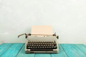 typewriter is on top of a blue table